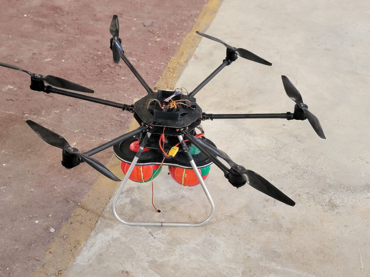 Heavy-lift agricultural hexacopter rigged for field deployment